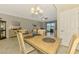 The dining area has a light wood table set and sliders to a lanai with lake views at 20390 Lagente Cir, Venice, FL 34293