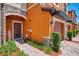 Inviting townhome entrance with a decorative glass door and manicured landscaping at 20390 Lagente Cir, Venice, FL 34293