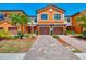 Charming two-story townhome with a brick driveway and a well-maintained front yard at 20390 Lagente Cir, Venice, FL 34293