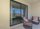 The screened lanai features comfortable wicker seating and scenic lake views through sliding glass doors at 20390 Lagente Cir, Venice, FL 34293