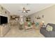 Open living room has neutral tones, tile floor, and access to dining area at 20390 Lagente Cir, Venice, FL 34293