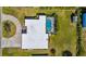 Aerial view of the home showing the pool, backyard, and circular driveway at 205 Cavallini Dr, Nokomis, FL 34275