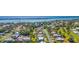 Wide aerial shot shows a serene waterfront community featuring a mix of homes and lush greenery along the coast at 205 Cavallini Dr, Nokomis, FL 34275