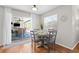 Bright dining area with sliding glass doors leading to outdoor space with hardwood flooring at 205 Cavallini Dr, Nokomis, FL 34275