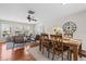 Open dining and living area with hardwood floors, modern decor, and plenty of natural light at 205 Cavallini Dr, Nokomis, FL 34275