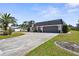 Charming single-story home boasts a well-manicured lawn, spacious driveway, and a two-car garage at 205 Cavallini Dr, Nokomis, FL 34275