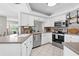 Bright kitchen featuring white cabinets, stainless steel appliances, and a convenient layout at 205 Cavallini Dr, Nokomis, FL 34275