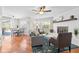 Cozy living room with hardwood floors, fireplace, and access to the dining area and outdoor patio at 205 Cavallini Dr, Nokomis, FL 34275