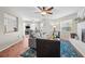 Inviting living room with hardwood floors, fireplace, and seamless transition to the kitchen and dining area at 205 Cavallini Dr, Nokomis, FL 34275