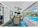 Covered patio featuring outdoor seating, ceiling fans, and views of a screened-in pool at 205 Cavallini Dr, Nokomis, FL 34275