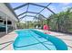 Screened-in pool with a basketball hoop and plenty of space for outdoor fun and relaxation at 205 Cavallini Dr, Nokomis, FL 34275