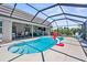 Gorgeous in-ground pool features a screened-in enclosure with patio and outdoor seating area at 205 Cavallini Dr, Nokomis, FL 34275
