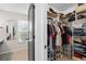 Organized walk-in closet featuring shelving, hanging racks and storage for shoes at 205 Cavallini Dr, Nokomis, FL 34275
