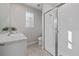 Bright bathroom featuring white cabinets, stone countertops, and a glass enclosed shower at 20591 Ovid Ln, Venice, FL 34293