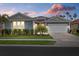 Beautiful single-story home with lush landscaping, a two-car garage, and solar panels, nestled in a vibrant community at 20591 Ovid Ln, Venice, FL 34293