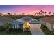 Charming single-Gathering home with a manicured lawn, solar panels, and a brick driveway, surrounded by palm trees at 20591 Ovid Ln, Venice, FL 34293