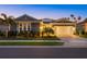 Charming single-story home featuring a well-kept lawn, paved driveway, and a two-car garage at 20591 Ovid Ln, Venice, FL 34293
