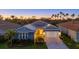 Charming single-Gathering home with a manicured lawn, solar panels, and a brick driveway, surrounded by palm trees at 20591 Ovid Ln, Venice, FL 34293