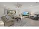 Bright living room with comfortable seating, stylish decor, and a large sliding glass door at 20591 Ovid Ln, Venice, FL 34293