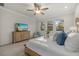 Inviting main bedroom features a ceiling fan, natural light, a wood dresser, and a light, beachy aesthetic at 20591 Ovid Ln, Venice, FL 34293