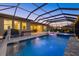 Spacious screened-in pool with hot tub and outdoor dining area at 20591 Ovid Ln, Venice, FL 34293