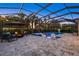 Beautiful pool with spa, lounge area, and fire pit for entertaining in the screened enclosure at 20591 Ovid Ln, Venice, FL 34293
