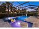 Relaxing screened-in pool and spa with lounge chairs and palm tree accents at 20591 Ovid Ln, Venice, FL 34293
