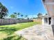 Spacious backyard featuring a stone patio, lush green lawn, and privacy fence, ideal for outdoor activities and entertaining at 2108 Lee Ln, Sarasota, FL 34231