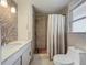 Bathroom featuring a shower with decorative stone, and a modern white sink and toilet at 2108 Lee Ln, Sarasota, FL 34231