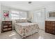 Bright bedroom with light walls, two windows, terrazzo floors, and comfortable furnishings at 2108 Lee Ln, Sarasota, FL 34231