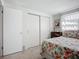 Bright bedroom with light walls, a window, and closet with sliding doors at 2108 Lee Ln, Sarasota, FL 34231