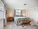Bright bedroom featuring light walls, terrazzo floor, two windows, and comfortable furnishings at 2108 Lee Ln, Sarasota, FL 34231