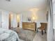 Bright bedroom with light walls, a stylish rug, dresser, and ensuite bathroom at 2108 Lee Ln, Sarasota, FL 34231