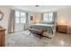 Bright bedroom with light walls, two windows, stylish rug, and a comfortable wicker bench at 2108 Lee Ln, Sarasota, FL 34231