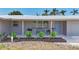 Charming front porch with updated landscaping, featuring seating, stylish tile flooring, and a baby-blue front door at 2108 Lee Ln, Sarasota, FL 34231