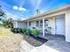 Beautifully landscaped front porch with tiled patio and seating, perfect for relaxation at 2108 Lee Ln, Sarasota, FL 34231