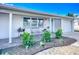 Charming home featuring a covered front porch and a well-manicured lawn with landscaping at 2108 Lee Ln, Sarasota, FL 34231