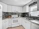 Modern kitchen featuring granite counters, tile backsplash, and stainless steel sink at 2108 Lee Ln, Sarasota, FL 34231