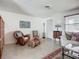Bright living room with terrazzo floors, a comfortable sofa, and ample natural light at 2108 Lee Ln, Sarasota, FL 34231