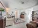 Open living room featuring terrazzo floors, large windows, and seamless flow into the kitchen at 2108 Lee Ln, Sarasota, FL 34231