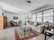Well-lit living room with comfortable seating, a glass coffee table, and ample natural light at 2108 Lee Ln, Sarasota, FL 34231