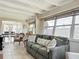 Well-lit living room flows into the dining area, featuring cozy seating and multiple windows at 2108 Lee Ln, Sarasota, FL 34231