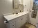 Bathroom vanity with white cabinets, countertop, mirror, and adjacent water closet at 22 Nautical Dr, North Port, FL 34287