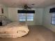 Bright bedroom featuring neutral carpet and a lighted ceiling fan at 22 Nautical Dr, North Port, FL 34287