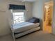 Bedroom featuring a daybed with trundle and an ensuite bathroom with patterned shower curtain at 22 Nautical Dr, North Port, FL 34287