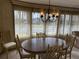 Bright dining area featuring a chandelier, and a large window with views of the outdoors at 22 Nautical Dr, North Port, FL 34287