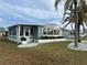 Well-kept home featuring a tidy lawn, white rock landscaping, and an enclosed Florida room at 22 Nautical Dr, North Port, FL 34287