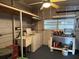 Large laundry room with sink, washer, dryer, and storage shelves at 22 Nautical Dr, North Port, FL 34287