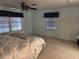 Main bedroom with a ceiling fan, two windows with blinds, and carpeted floors at 22 Nautical Dr, North Port, FL 34287