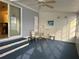 Enclosed patio featuring ceiling fan, blue carpet, and casual seating at 22 Nautical Dr, North Port, FL 34287